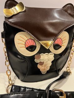 "Elevate your accessory game with our Vintage Ibiza Yenzi Small Owl Purse. This adorable crossbody bag, crafted from faux leather, combines fashion and fun seamlessly. Carry your essentials in style with this unique and charming animal-themed shoulder purse. Condition: Vintage Excellent Measurement's : 25\" High With Strap 7.5\" Wide 8\" Long 2\" Bottom  Sold as is Review all pictures closely. Most of my items are vintage and used, they will all show some signs of light wear or use. Major flaws Cute Black Shoulder Bag For Party, Cute Party Shoulder Bag With Adjustable Strap, Cute Gold Bags For Everyday Use, Cute Mobile Phone Bag For Party, Cute Gold Bag, Cute Party Mobile Phone Bag, Cute Party Bag For Mobile Phones, Cute Party Bag With Adjustable Strap, Cute Party Bags With Adjustable Strap