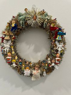 a christmas wreath is hanging on the wall next to a white wall with an ornament