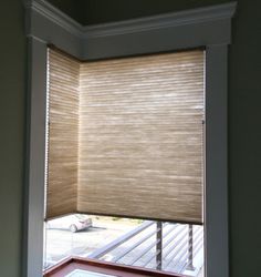 an open window with blinds on the outside