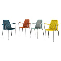 four different colored chairs sitting next to each other