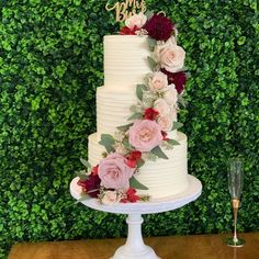 a white wedding cake with flowers on top