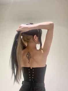 a woman with long hair wearing a black corset