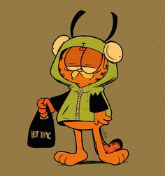 an orange cat in a green hoodie holding a bag