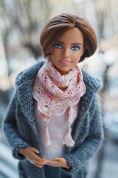 a barbie doll wearing a knitted scarf