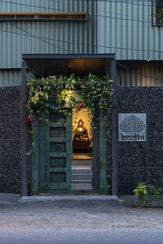 an entrance to a building with plants growing on it