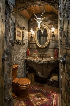 a rustic bathroom with an antler head on the wall