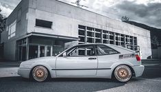 a white car parked in front of a building