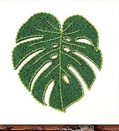 a green leaf is shown in the shape of a heart