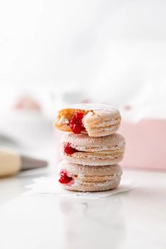 a stack of doughnuts sitting on top of a white counter next to a knife