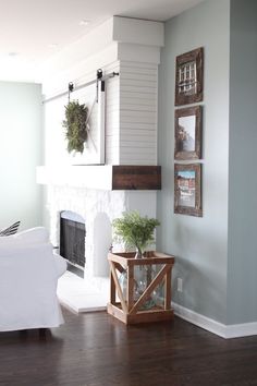 a living room filled with furniture and a fire place in the center of the room