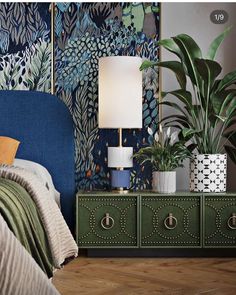 a bedroom with blue and green wallpaper, two planters on the nightstand