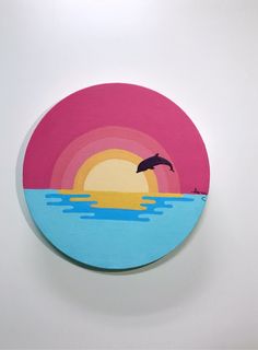 a painting of a dolphin jumping out of the water at sunset with a rainbow in the background