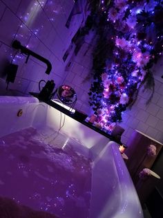 a bathtub filled with purple water next to a christmas tree