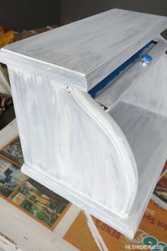 an unfinished piece of furniture being painted white