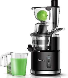 a juicer filled with green liquid next to a blender