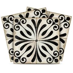 four black and white tiles with swirl designs on the top, one in square shape