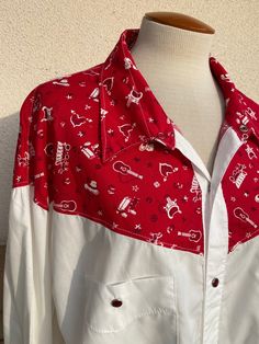 "Vintage white western shirt with a fun red cowboy print yoke and red pearl snaps up the front and at the wrists. Excellent vintage condition. Clean and ready to wear. There are no labels. Fabric feels like cotton/poly blend. Size 4XL-5XL is just an estimate. Please check measurements for an accurate fit. Questions are welcome! Shirt was measured across the front side lying flat. underarm to underarm 27\" length 33\" shoulder 24 1/2\"" Western Style Red Long Sleeve Tops, Red Western Long Sleeve Tops, Red Long Sleeve Western Top, Red Western Style Tops For Ranch, Vintage Red Tops For Rodeo, White Western Shirt, Cowboy Print, Bombshell Dress, Pearl Snap Shirt