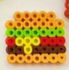 a close up of a lego sandwich made out of plastic beads on a white surface