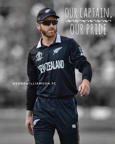 a man in black jersey and cap walking on field with words above him that read our captain, our pride