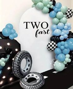 two fast balloons and tires are on display in front of a sign that says, two fast