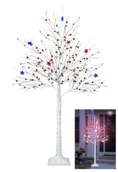 a lighted tree with red, white and blue stars on it next to a potted plant