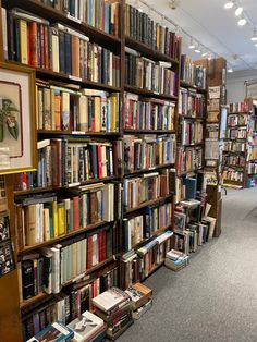 a library filled with lots of books on top of wooden shelves next to each other