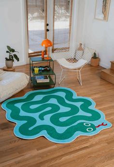 a living room with hard wood flooring and a rug on the floor that looks like a maze