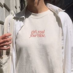 a woman wearing a white shirt with the words girl, read your bible on it