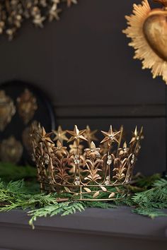 a gold crown sitting on top of a mantle