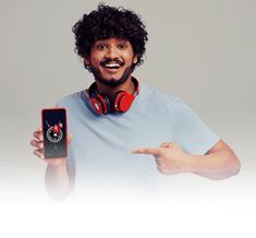 a man wearing headphones and pointing to an mp3 player in front of his face