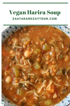 a bowl filled with bean and vegetable soup on top of a blue and white plate