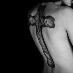 a woman with a cross tattoo on her back