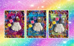 two cookies with decorations on them sitting in front of a rainbow background and some glitter