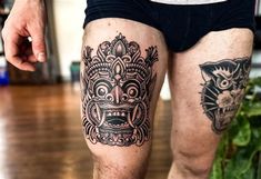 a man with some tattoos on his legs