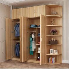 an open closet with clothes and handbags on shelves next to a wall mounted mirror