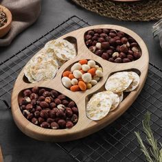 a wooden tray filled with nuts and crackers