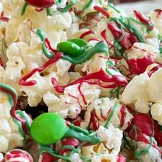 a bowl filled with popcorn covered in candy and sprinkles on top of it