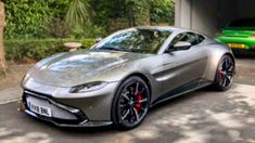 a silver sports car parked in front of a garage