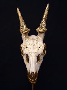 a white and gold bull skull with horns