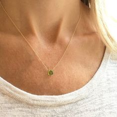 This genuine peridot gemstone sits on a dainty gold filled, sterling silver, rose gold filled or 14k gold chain. Subtle and simple, this beautiful semi-precious stone necklace is perfect by itself or for layering with other necklaces. Peridot is the birthstone for August. The length on the model is 16 inches. Jewelry is handmade by us in our NYC studio. We focus on craftsmanship and quality using only the highest quality materials and handpicked genuine gemstones.  PACKAGING We take pride in cre Minimalist May Birthstone Charm Necklace, Dainty Yellow Gold Charm Necklace For May Birthstone, Minimalist Yellow Gold Charm Necklace For May Birthstone, Dainty Yellow Gold Charm Necklace With May Birthstone, Dainty Yellow Gold Charm Necklace With Emerald, Delicate Gold Sterling Silver Birthstone Necklace, Delicate Gold Birthstone Necklace In Sterling Silver, Minimalist Peridot Birthstone Jewelry, Minimalist Gold Peridot Jewelry