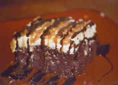 a piece of cake with chocolate and caramel drizzled on the top