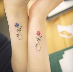 two matching tattoos with roses on their arms