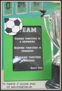 a soccer trophy sitting next to a chalk board