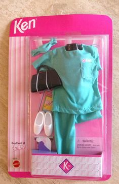 a doll in a box with clothes and shoes on the floor next to it's packaging