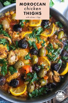 moroccan chicken thighs with olives and peppers in a skillet on a wooden table