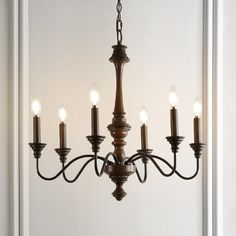 Based on historic wrought iron chandeliers, our rustic 6-light design features a quality wood-look finish. Perfectly sized for a farmhouse dining room, tall entry, or kitchen with high ceilings, our chandelier is just 25" wide and features tall candles with LED candle bulbs. Use this versatile chandelier in a modern farmhouse, French country or Tuscan style home, or to add character to a rustic, industrial space. JONATHAN Y Oakley 25" Rustic 6-Light Oil-Rubbed Black Farmhouse Bare Bulb Chandelie Midcentury Farmhouse, Tall Candles, Tuscan Style Homes, Century Farmhouse, Wire Installation, Farmhouse French Country, Wrought Iron Chandeliers, Tall Candle, Bronze Chandelier