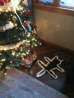 a decorated christmas tree in the corner of a room