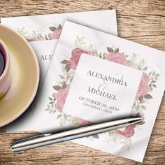 two folded wedding cards next to a cup and saucer