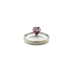 This is part of Chairish’s Fine Jewelry assortment.  This 18k white gold ring features a beautifully coloured heart-shaped garnet. The garnet is a saturated deep magenta, with facets that sparkle in many different hues of pink and red. It is prong set with three prongs; the back of the carriage or underside of the ring is a heart shape as well, for an adorable added touch. A wonderful sweetheart ring , this is the perfect gift to show someone your love or your self love.  The rings weighs 2.9 gr Classic Heart-shaped Ruby Ring For Formal Occasions, Classic Heart-shaped Ruby Ring, Formal Heart Ring With Brilliant Cut, Heart-shaped Gemstone Ring For Valentine's Day, Classic Heart Cut Ruby Ring For Valentine's Day, Heart Shaped Ruby Ring In White Gold For Wedding, Elegant Heart Shaped Sapphire Ring For Formal Occasions, Fine Jewelry Gemstone Heart Ring For Proposal, White Gold Heart-shaped Ruby Wedding Ring