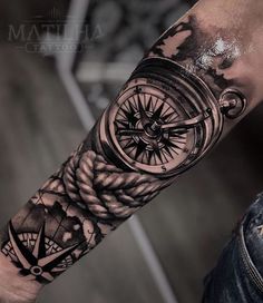 a man with a compass tattoo on his arm